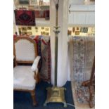 A brass corinthian column adjustable standard lamp on square stepped base with four cast paw feet