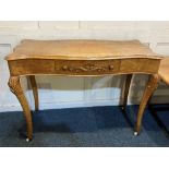 A Louis XV style satinwood side table with serpentine shaped top, single centre drawer, on scroll