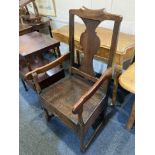 A 17th/18th century oak elbow chair with baluster shaped back splat, solid seat with drawer, on