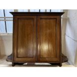 An Edwardian mahogany wall cabinet, with two doors flanked by shelves with boxwood and rosewood
