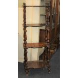 A Victorian mahogany four tier whatnot with graduating shaped shelves on turned column supports (a/