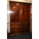 A George III mahogany linen press cupboard, with panelled doors enclosing four sliding shelves, over