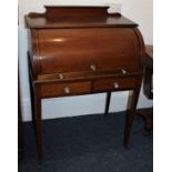 An Edwardian inlaid mahogany cylinder desk, with rising front enclosing an interior of small drawers