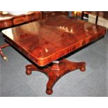 A Victorian mahogany breakfast table, with rectangular flame mahogany tilt top and baluster pedestal