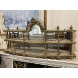 A 19th century continental two-tier wall shelf possibly Italian, with arched cornice, turned