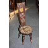 A carved oak spinners chair pierced heart back support with roundals, on turned legs