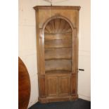 An 18th century style pine barrel-backed corner cabinet, the arched open front with carved shell