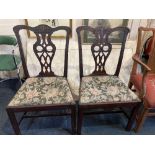 A pair of Chippendale style dining chairs with pierced vase backs, drop in upholstered seats on