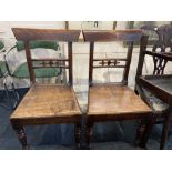 A pair of 19th century hall chairs with fleur de lys carved bar backs, solid seats on turned