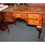 A Queen Anne style walnut side table, with rectangular quarter veneered top, kneehole drawer flanked