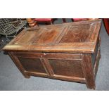 An 18th century oak coffer with panelled top and sides, on block feet 99cm
