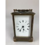 A brass and bevelled glass cased carriage clock, 14.5cm high