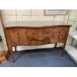 A reproduction mahogany serpentine fronted sideboard, with central drawer flanked by two panel doors