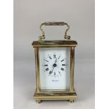 A gilt brass and bevelled glass cased carriage clock, the dial signed Martin & Co, Cheltenham, the