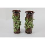 A pair of Rye pottery cylindrical hop ware vases, with relief decoration of a green hop branch on