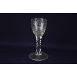 An 18th century wine glass, round funnel bowl with an engraved circuit of ovals and stars, the