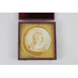 A 19th century circular cast portrait profile of a lady, in fitted case, 10cm diameter (a/f)