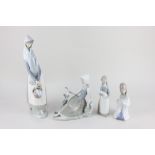 Two Lladro porcelain figures of ladies, one seated beside a dove, 17cm high, the other holding a