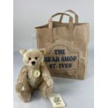 A Steiff Classic teddy bear, in beige mohair, 27cm long, with all labels, in the Bear Shop, St Ive's