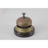 A brass service bell, mounted on wooden base, base 11cm diameter