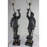 A pair of Continental spelter figures of soldiers, now as table lamps, mounted on hard stone
