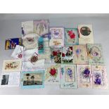 A collection of Victorian and later greetings cards and postcards, some with embroidered or