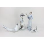 Two Lladro porcelain figures of ladies carrying umbrellas (one missing its canopy), to include a