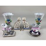 A pair of Staffordshire pottery seated cats, a pair of trumpet form vases, a miniature Coalport trio