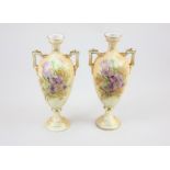 A pair of blush ivory style two-handled porcelain vases, decorated with irises and gilt