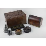 A carved oak box, the hinged lid with foliate decoration, 30cm, a brass bound desk tidy with domed