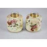 A pair of Royal Worcester porcelain blush ivory vases, of oval form, each decorated with flowers and