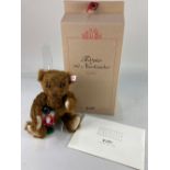 A Steiff limited edition teddy bear, holding a nutcracker, in russet mohair, 853/3000, with button