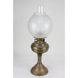 A brass oil lamp, with floral etched globe shade, 57cm high including glass flue