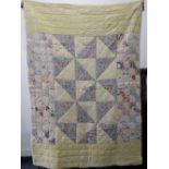 A Canadian Red Cross Society Quilt 1939-45, with yellow and floral patterned patchwork design,