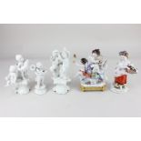 A Rudolstadt Volkstedt porcelain figure group of three putti playing instruments, on integral