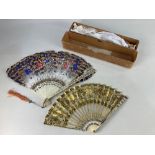 A 19th century carved bone and sequinned lace fan, with gold and silver coloured decoration,