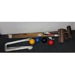 A croquet set comprising four mallets, four balls, a marker and a collection of metal hoops