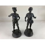 A pair of spelter figures of boys, one playing a drum, each on integral circular base, 36cm high (
