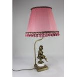 A gilt metal figural table lamp, the semi nude female figure on a rectangular brass base, 45cm high