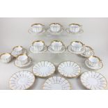 A Royal Copenhagen porcelain part tea set, decorated with gilt stripes on white ground, comprising