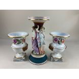 A porcelain table centrepiece, supported by the three graces, together with a pair of campana