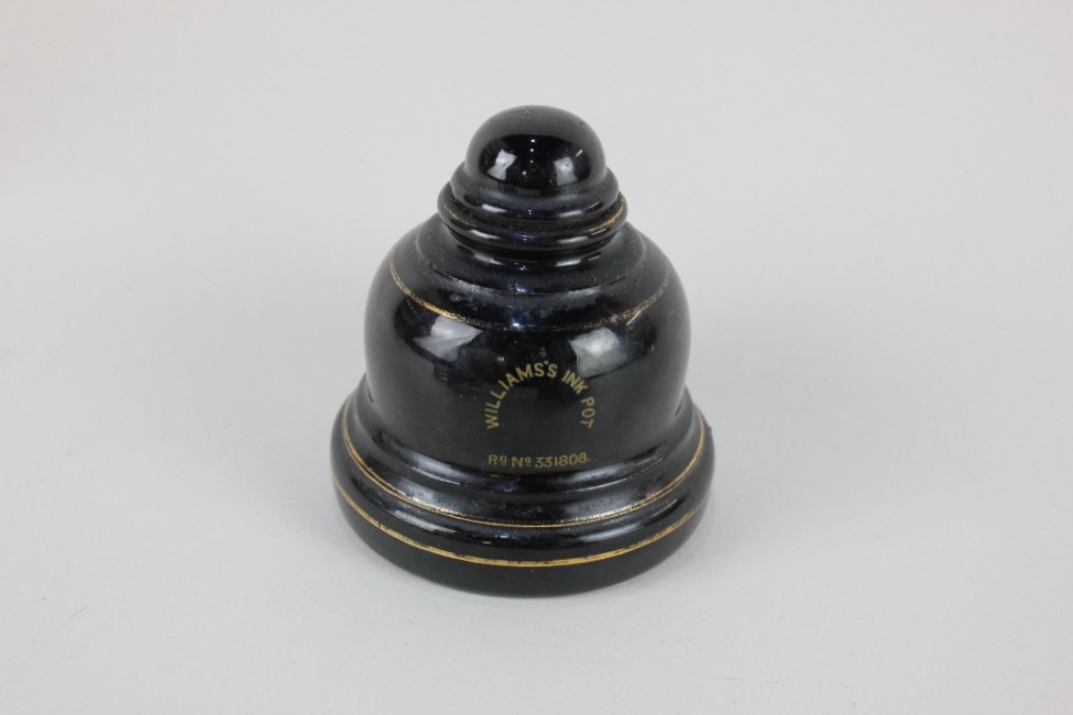 A Victorian bell shaped black glazed ink well, marked 'Williams's Ink Pot Rd No 331808, 11cm, and - Image 2 of 2