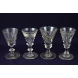 Four various early 19th century wine or spirit glasses, each with deceptive bowl, on knop stem,