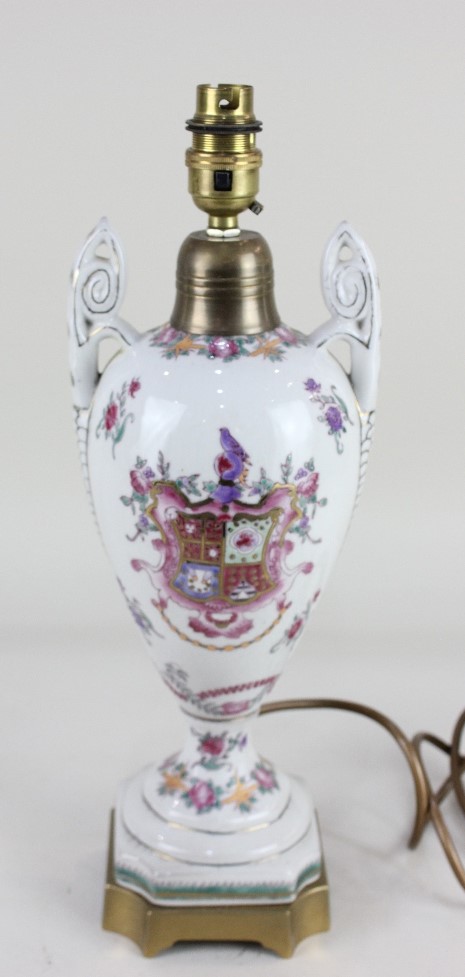 A brass mounted armorial porcelain table lamp, with two scroll handles, 39.5cm high