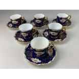 A set of six Coalport porcelain coffee cups and saucers, with floral and gilt design on blue