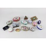 A collection of 19th century and later porcelain and enamel pill and trinket boxes, together with