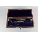 An Army and Navy part set of draughtsman's tools, in fitted rectangular brass bound walnut case,