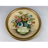 A 20th century chalk ware floral relief wall plaque, stamped FL Copyright No. 21, 38cm diameter