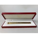 A Le Must de Cartier ballpoint pen, with a gilt textured finish and in a fitted leather case (a/f)