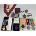 A collection of medals and badges, including a silver gilt Masonic medal, a 1929 The Royal Infirmary